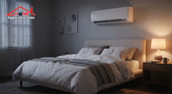 Quiet bedroom at night with a white wall-mounted split air conditioner above a made bed under soft lamp light
